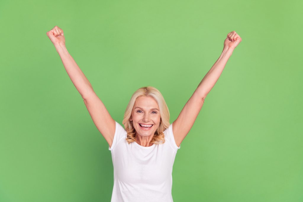 photo portrait senior woman overjoyed happy gesturing like winner isolated pastel green color background