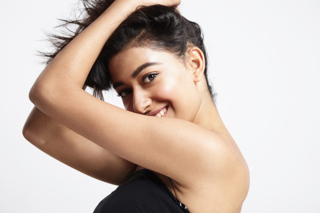 Upper body shot of a happy woman smiling at the camera